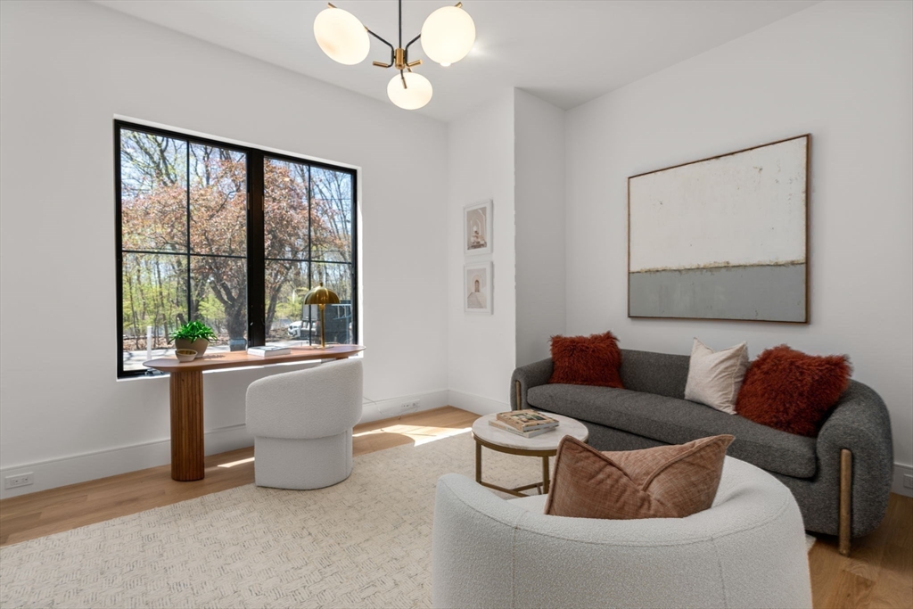 470 Quinobequin Road Newton, MA 02468 - Photo 15 of 37 a living room with furniture and a window