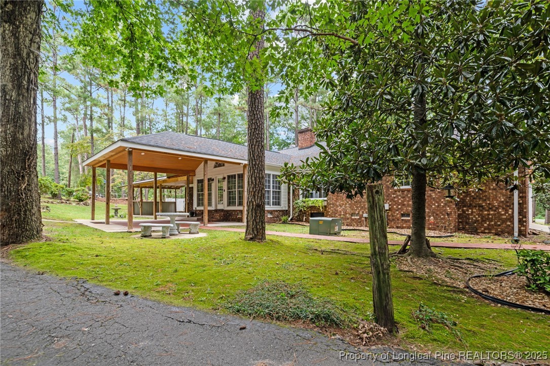 610 Maynard Lake Road Erwin, NC 28339 - Photo 5 of 49 a view of a house with a yard patio and fire pit