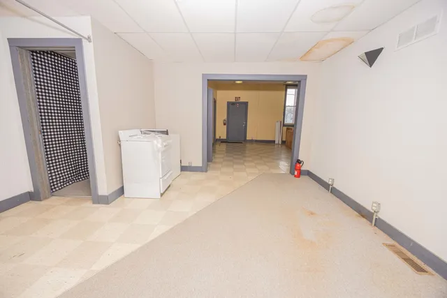 a room with a wooden floor and white walls