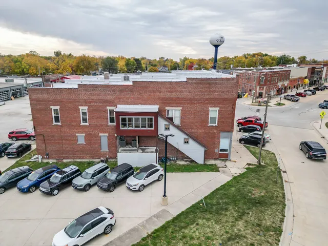 aerial view of a house with a yard and lake view