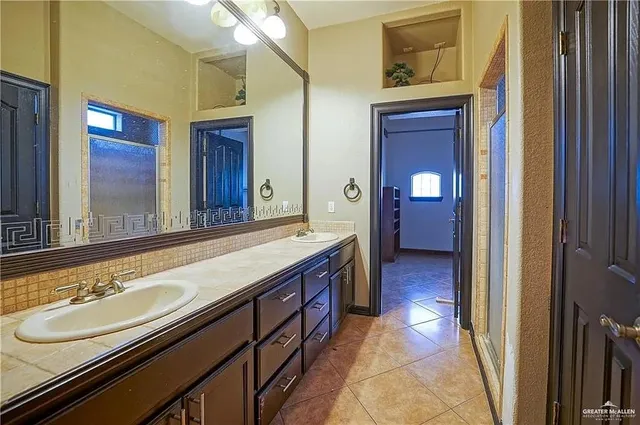 a bathroom with a sink and a large mirror