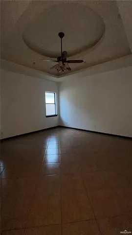 a view of a room with wooden floor and a window