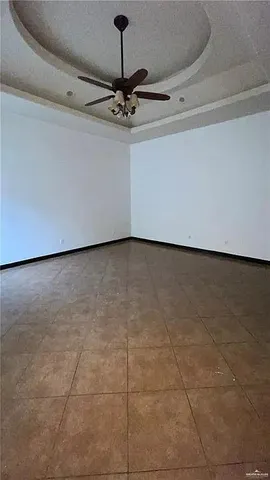 a view of a room with a ceiling fan and a projector
