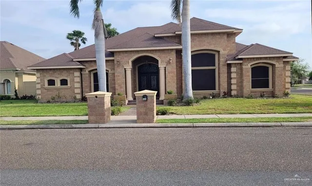 a view of house with garden and tall windows