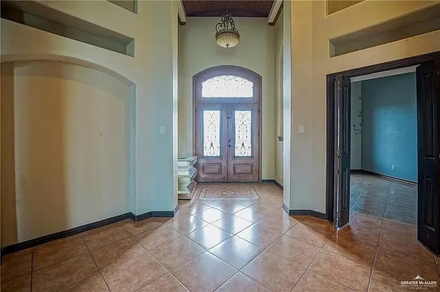 a view of a room with large mirror and furniture