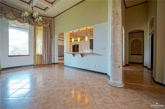a view of a big room with a chandelier and fireplace