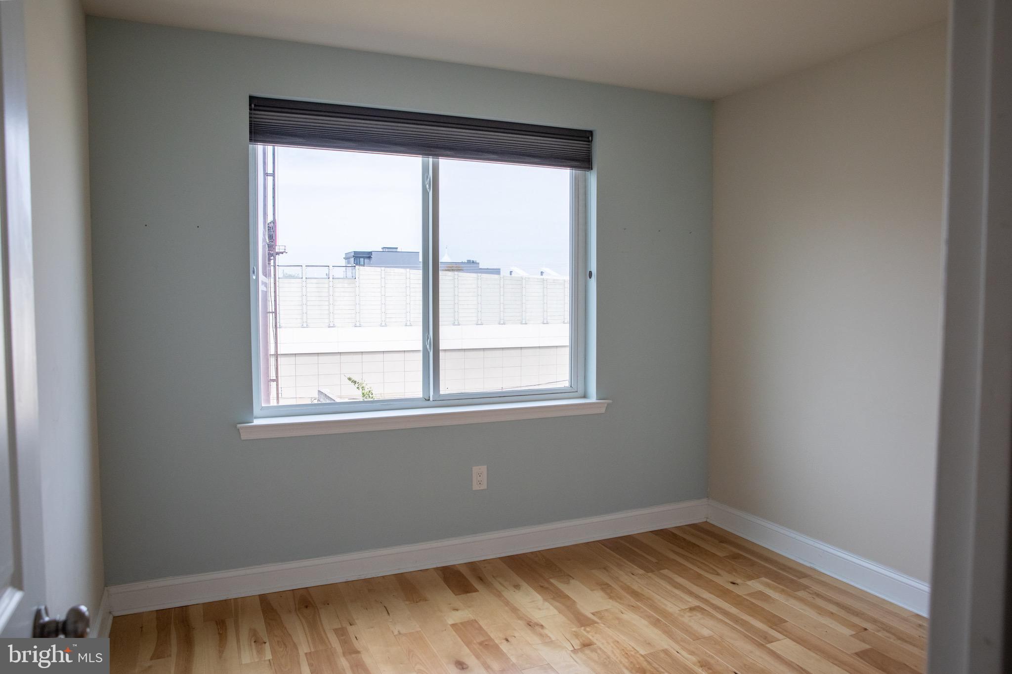 323 East Allen Street, Unit 4 Philadelphia, PA 19125 - Photo 11 of 24 a view of an empty room with wooden floor and a window