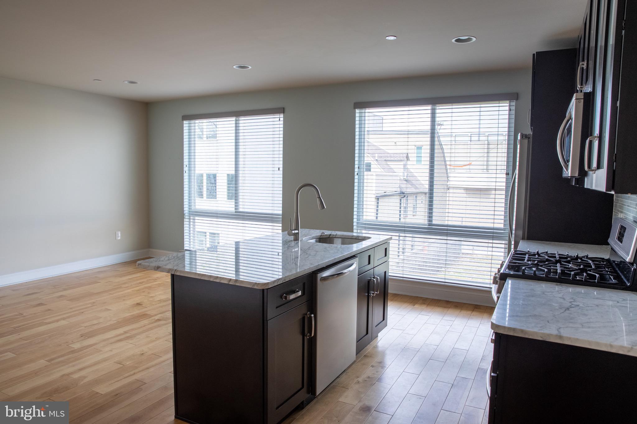 323 East Allen Street, Unit 4 Philadelphia, PA 19125 - Photo 5 of 24 a kitchen with counter top space and wooden floor