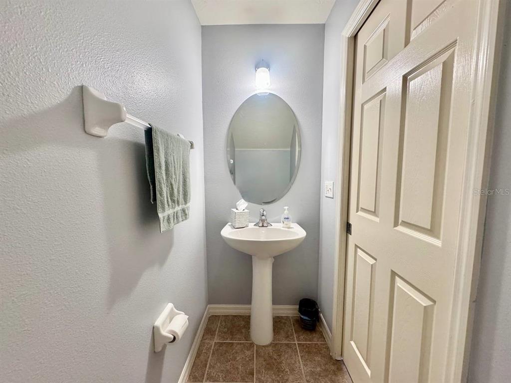 10035 Tranquility Way Tampa, FL 33625 - Photo 11 of 28 a bathroom with a sink toilet and mirror
