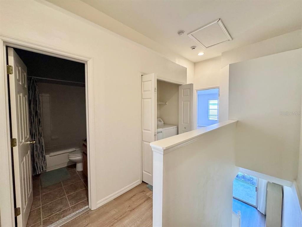 10035 Tranquility Way Tampa, FL 33625 - Photo 13 of 28 a view of a hallway with wooden floor