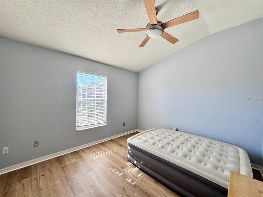 10035 Tranquility Way Tampa, FL 33625 - Photo 15 of 28 a bedroom with a bed and a window
