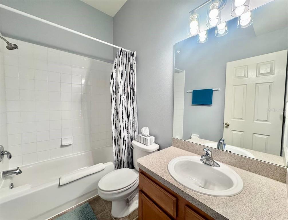 10035 Tranquility Way Tampa, FL 33625 - Photo 18 of 28 a bathroom with a sink toilet tub and shower
