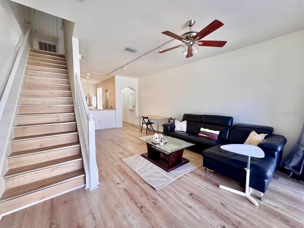 10035 Tranquility Way Tampa, FL 33625 - Photo 7 of 28 a living room with furniture and wooden floor