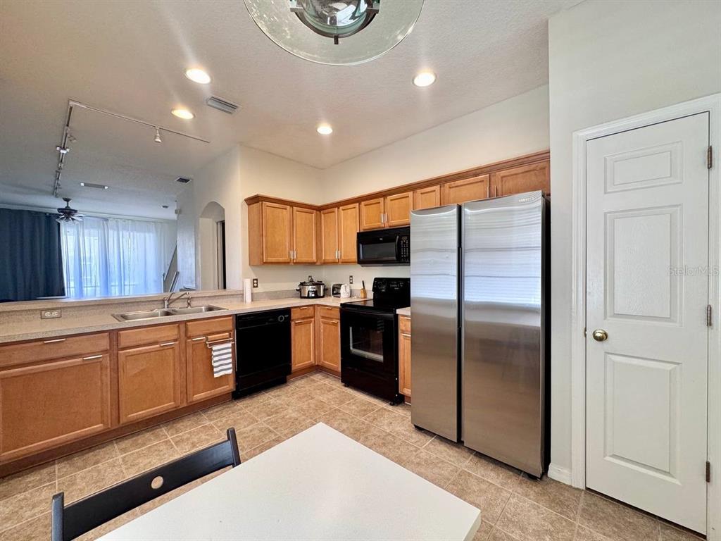 10035 Tranquility Way Tampa, FL 33625 - Photo 8 of 28 a large kitchen with a large counter top stainless steel appliances and cabinets