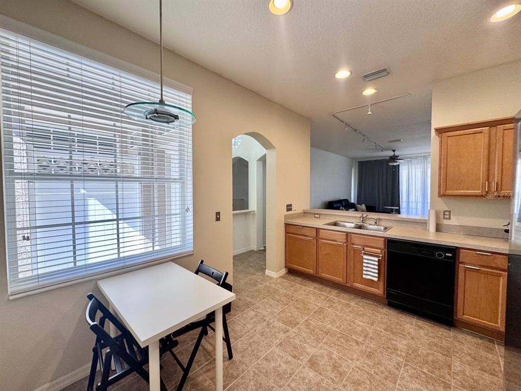 10035 Tranquility Way Tampa, FL 33625 - Photo 9 of 28 a large kitchen with kitchen island a sink a stove a refrigerator and a dining table