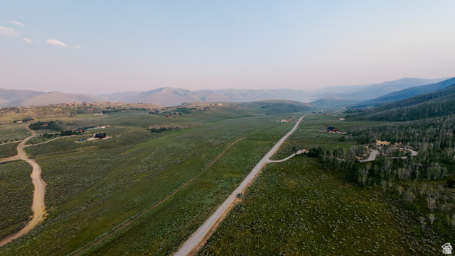55 North Dry Valley Road, Unit 65 Helper, UT 84526 - Photo 6 of 7 Expansive rural landscape featuring a long roadway, scattered residential structures, mature tree lines, and distant mountainous terrain