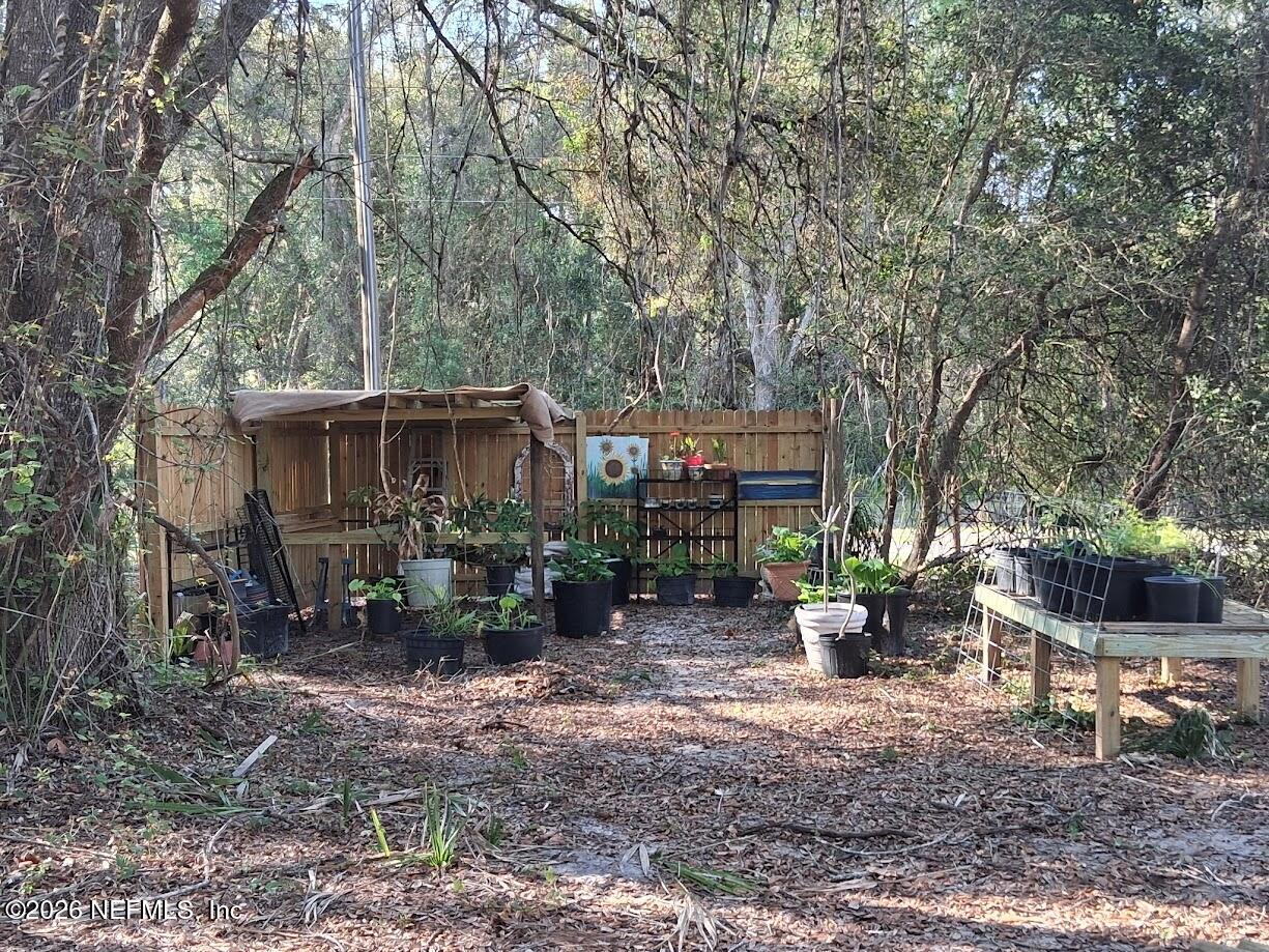 910 Paradise Boulevard Georgetown, FL 32139 - Photo 5 of 9 a backyard of a house with yard barbeque oven and outdoor seating
