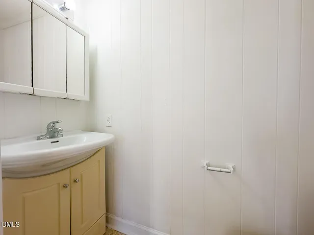 a bathroom with a sink and cabinets