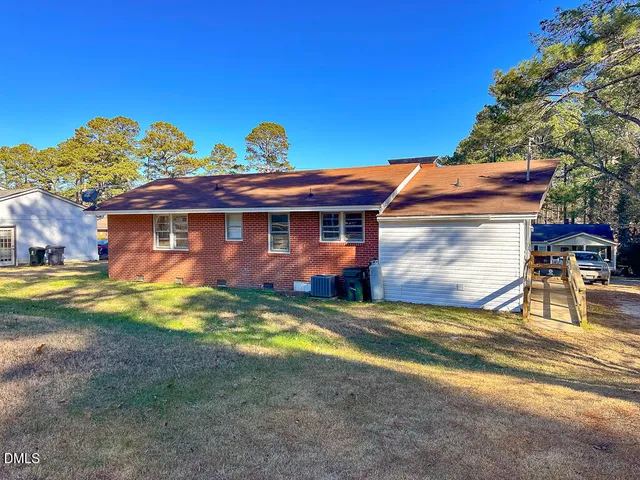 a view of a house with pool and sitting area
