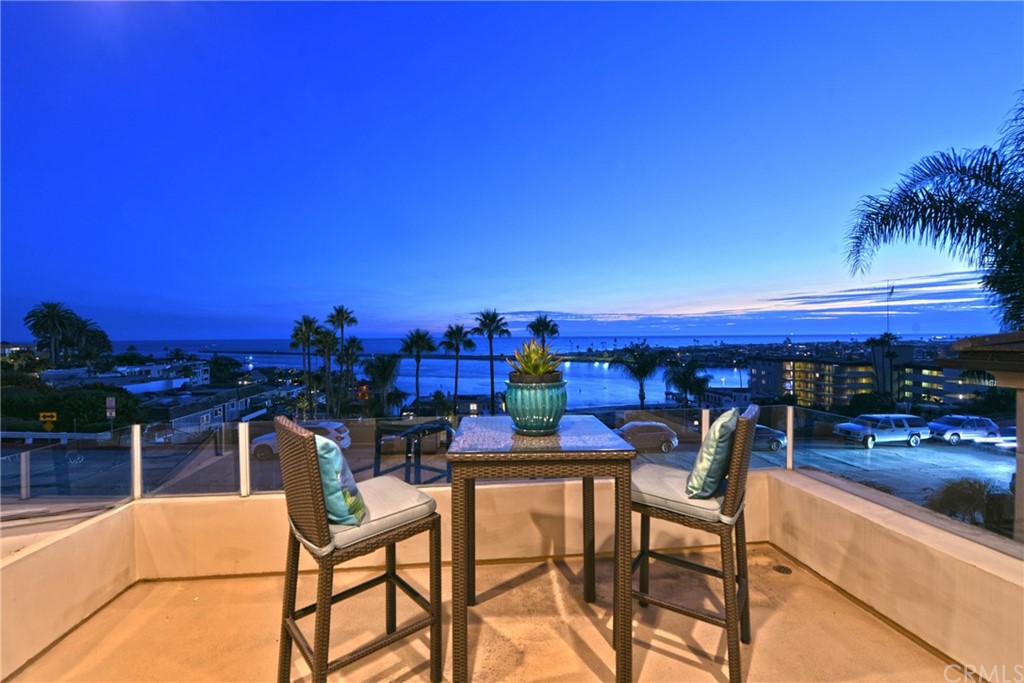 2624 Ocean Boulevard Corona del Mar, CA 92625 - Photo 2 of 10 a view of a chairs and table in patio with a lake view