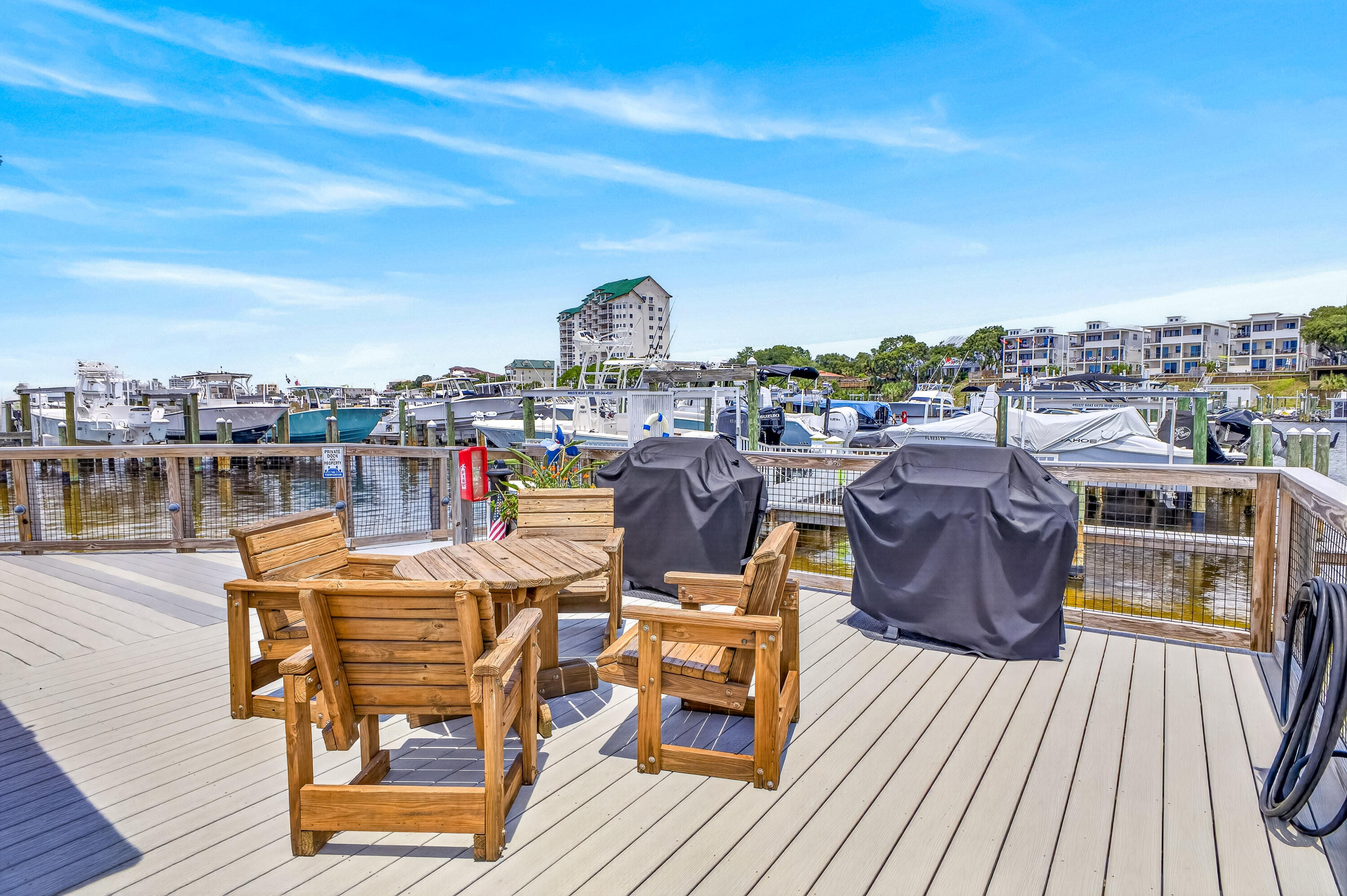 30 Moreno Point Road, Unit 703A Destin, FL 32541 - Photo 51 of 60 a view of a rooftop deck with chairs and wooden floor