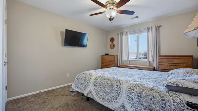 a bedroom with a large bed and a flat screen tv