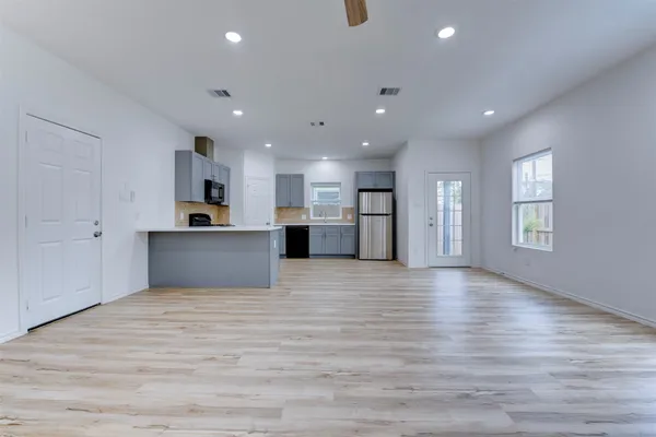a view of kitchen with refrigerator and window