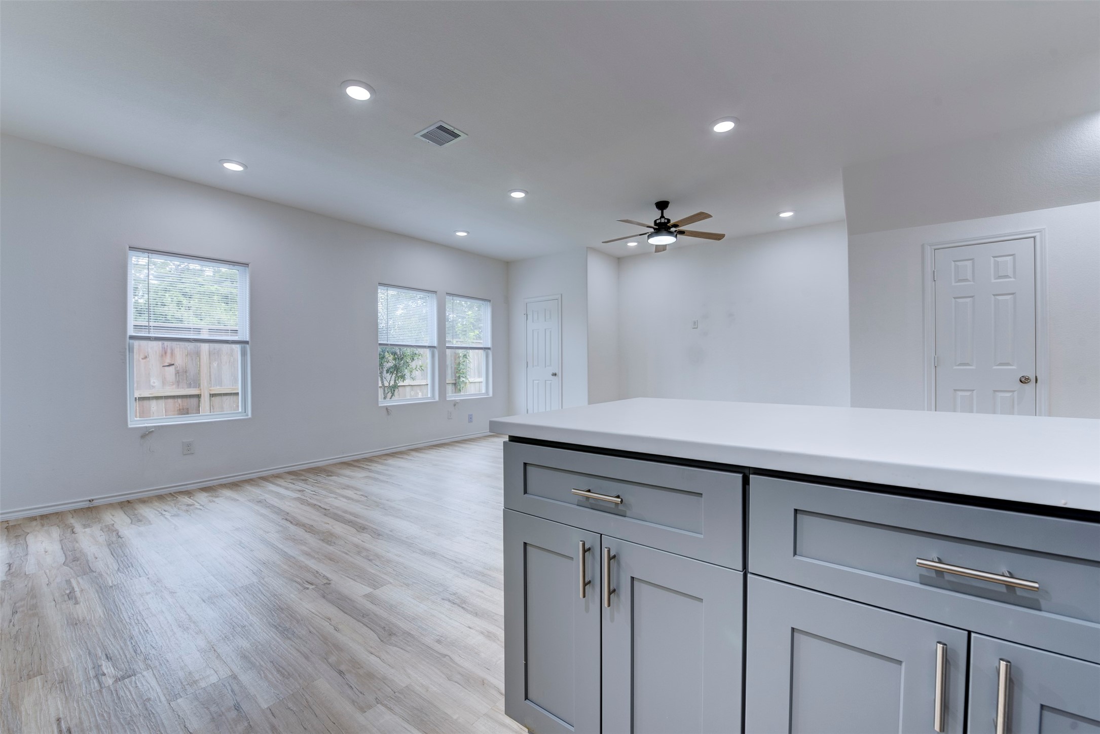 8203 Woodlyn Road, Unit F Houston, TX 77028 - Photo 16 of 29 a view of an empty room with wooden floor and a window