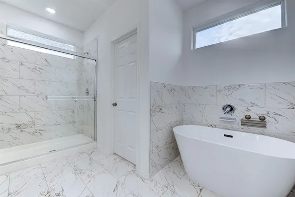a bathroom with a bathtub and a shower