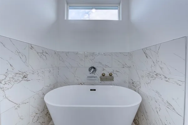 a white bath tub sitting in a bathroom