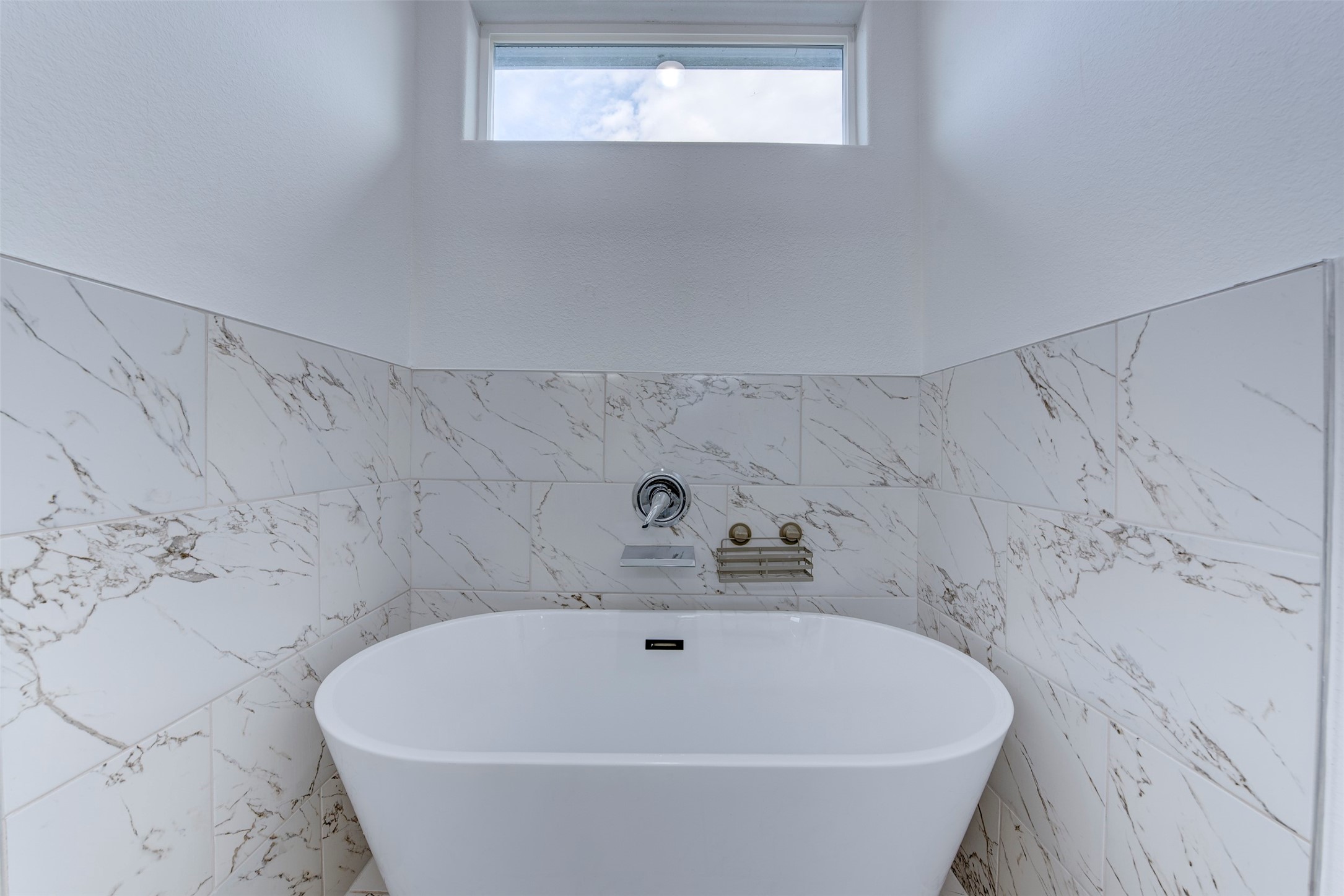 8203 Woodlyn Road, Unit F Houston, TX 77028 - Photo 22 of 29 a white bath tub sitting in a bathroom