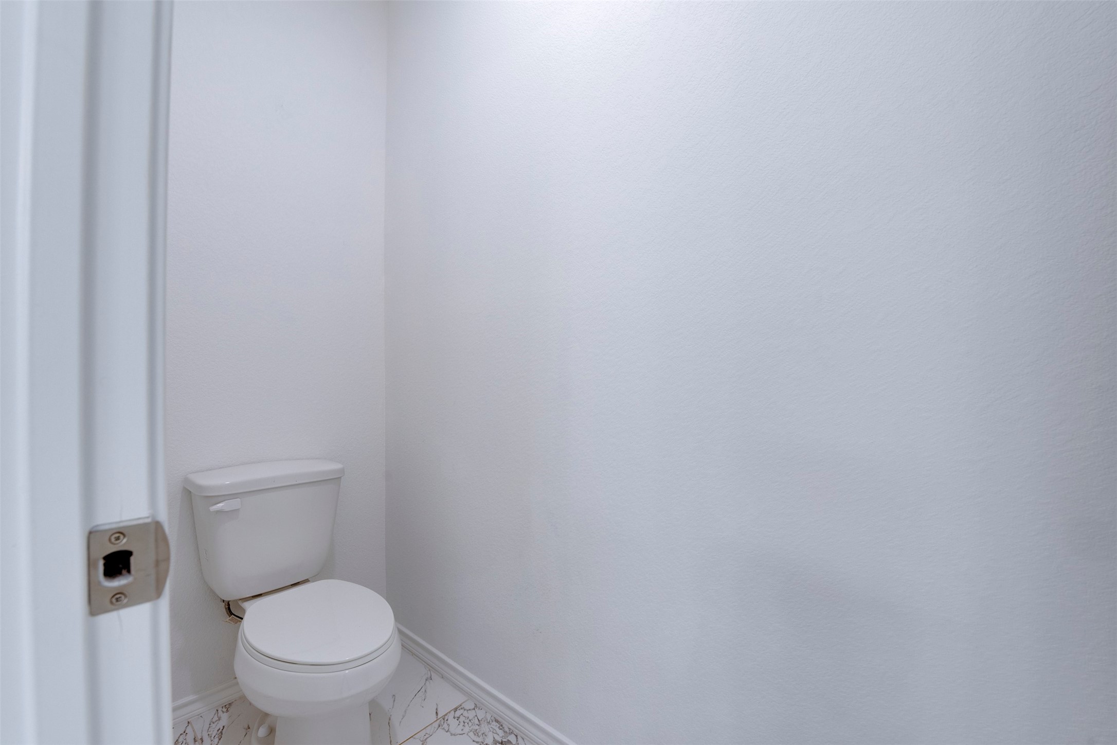 8203 Woodlyn Road, Unit F Houston, TX 77028 - Photo 25 of 29 a white toilet sitting next to a white wall