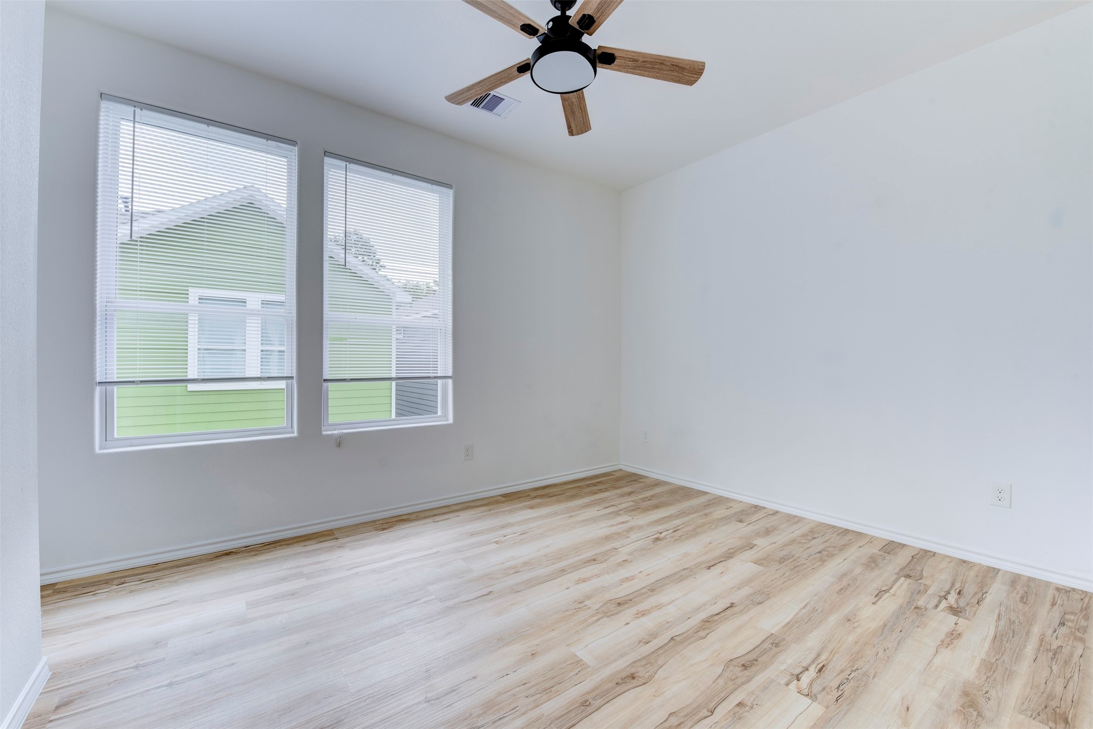 8203 Woodlyn Road, Unit F Houston, TX 77028 - Photo 28 of 29 a view of an empty room with wooden floor and a window