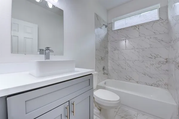 a bathroom with a sink a toilet and a bathtub