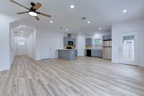 a view of a kitchen with a sink and a refrigerator