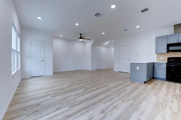 a view of a kitchen with a sink and a refrigerator