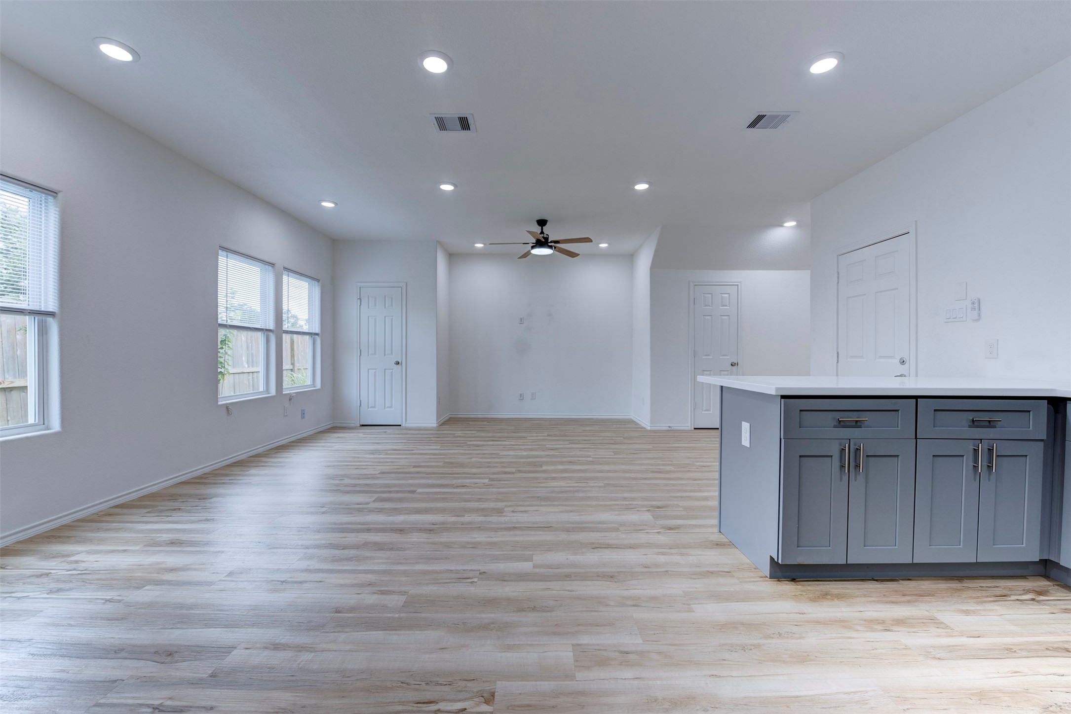 8203 Woodlyn Road, Unit F Houston, TX 77028 - Photo 8 of 29 an empty room with wooden floor and windows