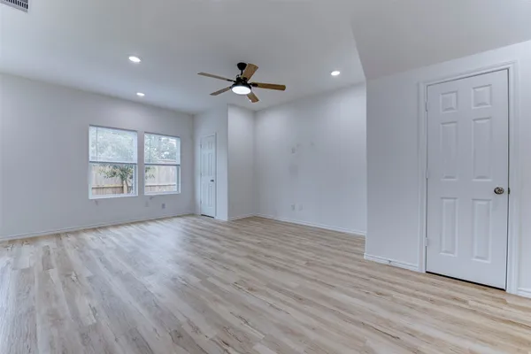 wooden floor in an empty room with a window