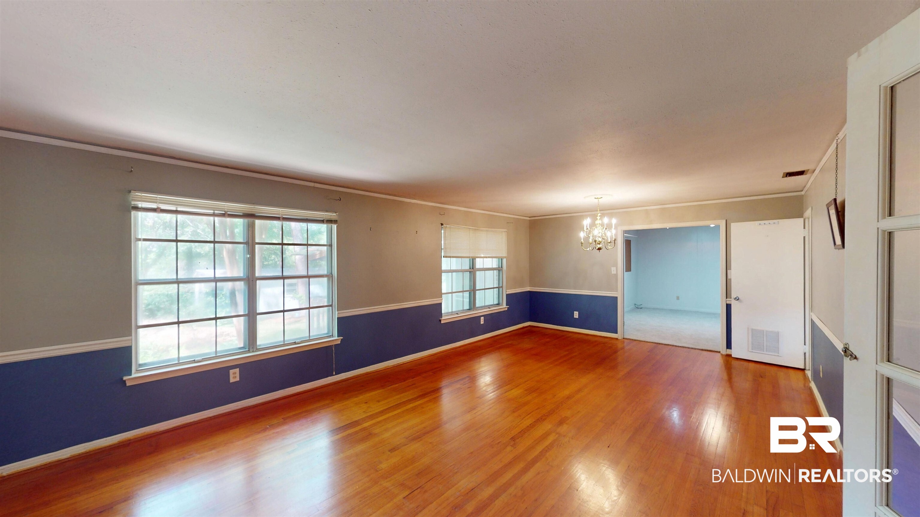 1075 Zurich Street Mobile, AL 36608 - Photo 12 of 35 Unfurnished room featuring hanging lights, wood finished floors, and ornamental molding