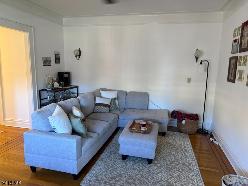 4 Riverside Drive, Unit 302 Cranford, NJ 07016 - Photo 5 of 9 a living room with furniture and a window