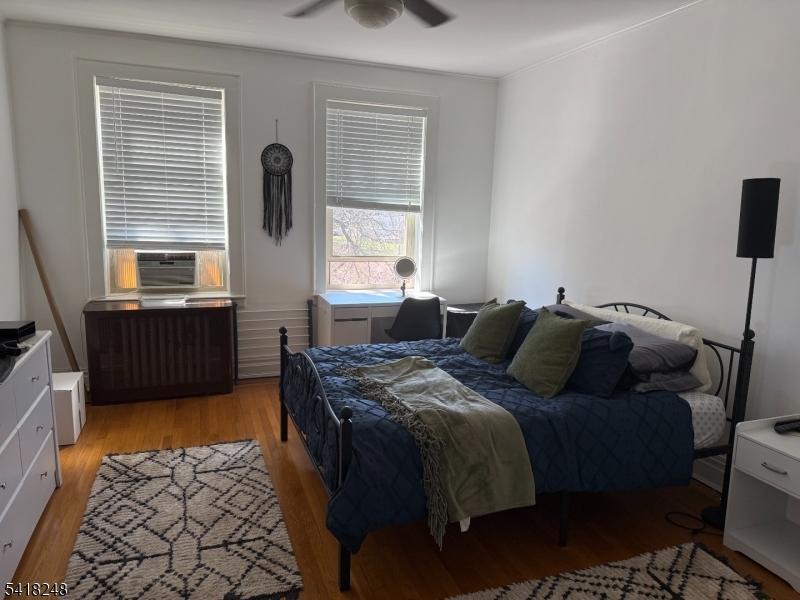 4 Riverside Drive, Unit 302 Cranford, NJ 07016 - Photo 7 of 9 a bed sitting in a bedroom next to a window