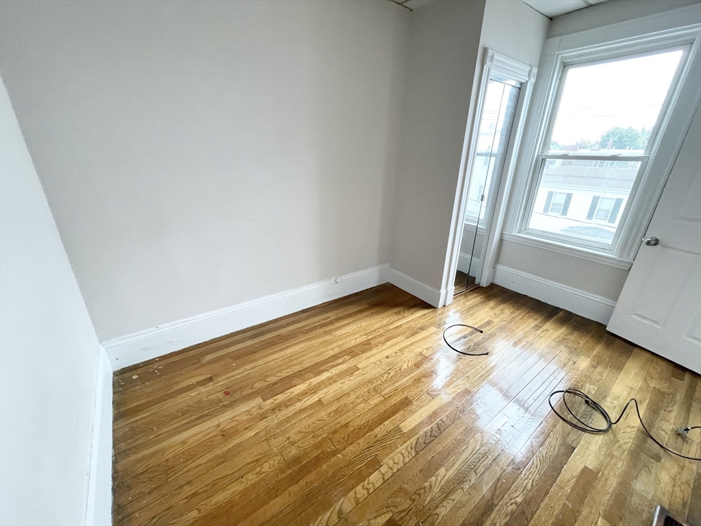 26-28 Harbor View Street, Unit 3 Boston, MA 02125 - Photo 8 of 9 a view of empty room with wooden floor and fan