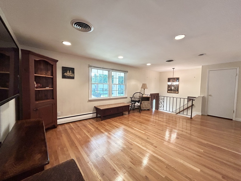 98 Sheffield Road Cranston, RI 02920 - Photo 3 of 23 a view of an empty room with a window and wooden floor