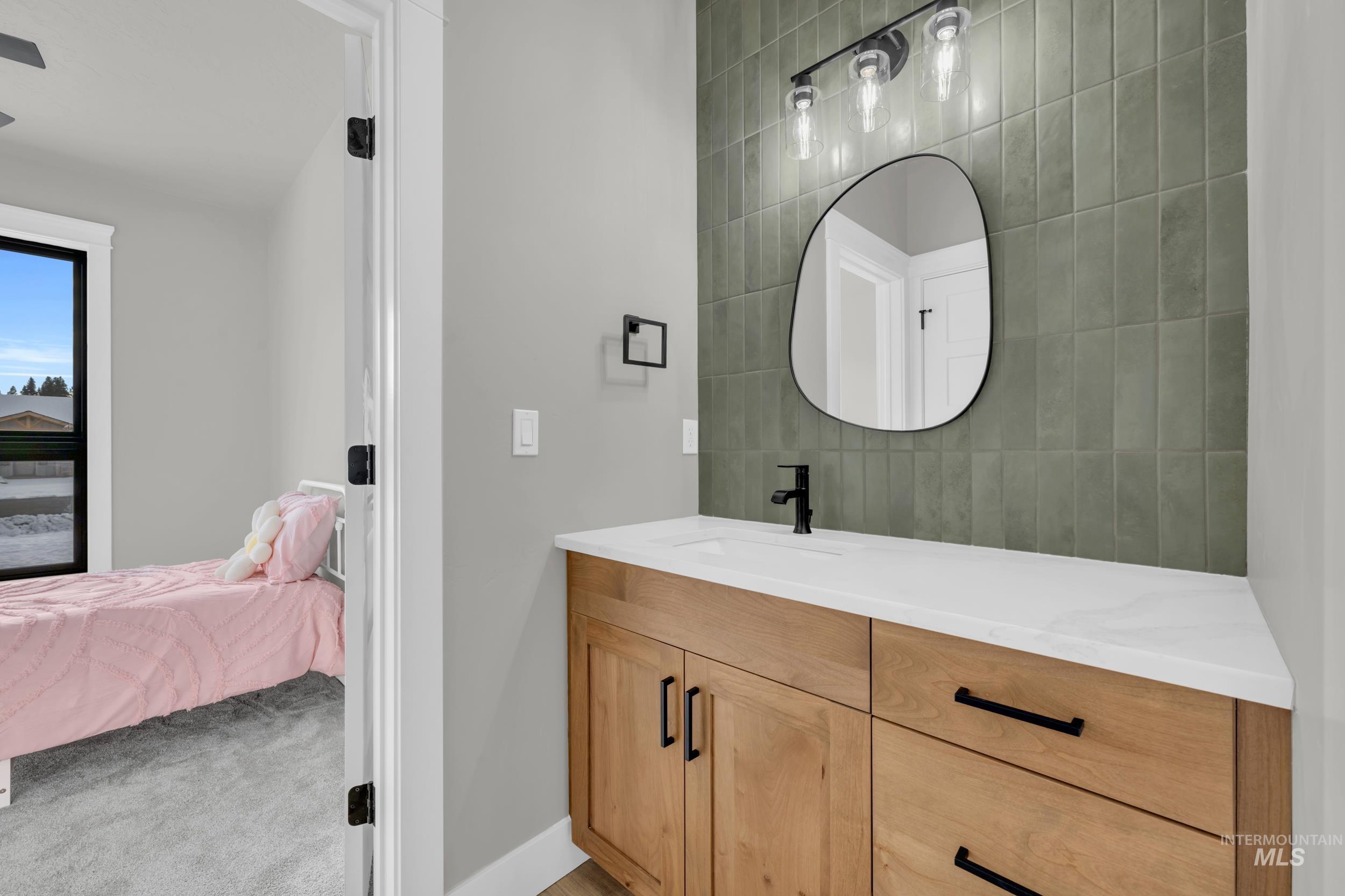 1107 Mo's Way McCall, ID 83638 - Photo 31 of 50 Bathroom featuring ensuite bathroom, vanity, and light colored carpet