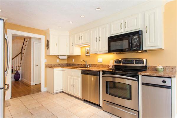 39 Circle Road Lexington, MA 02420 - Photo 7 of 24 a kitchen with granite countertop a stove top oven microwave and cabinets