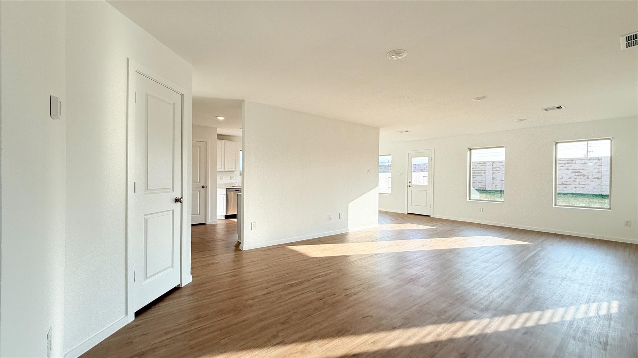 1122 Rustic Willow Drive Beasley, TX 77417 - Photo 3 of 8 a view of an empty room with wooden floor and a window