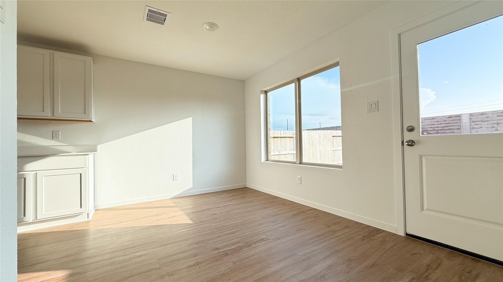 1122 Rustic Willow Drive Beasley, TX 77417 - Photo 4 of 8 an empty room with wooden floor and windows
