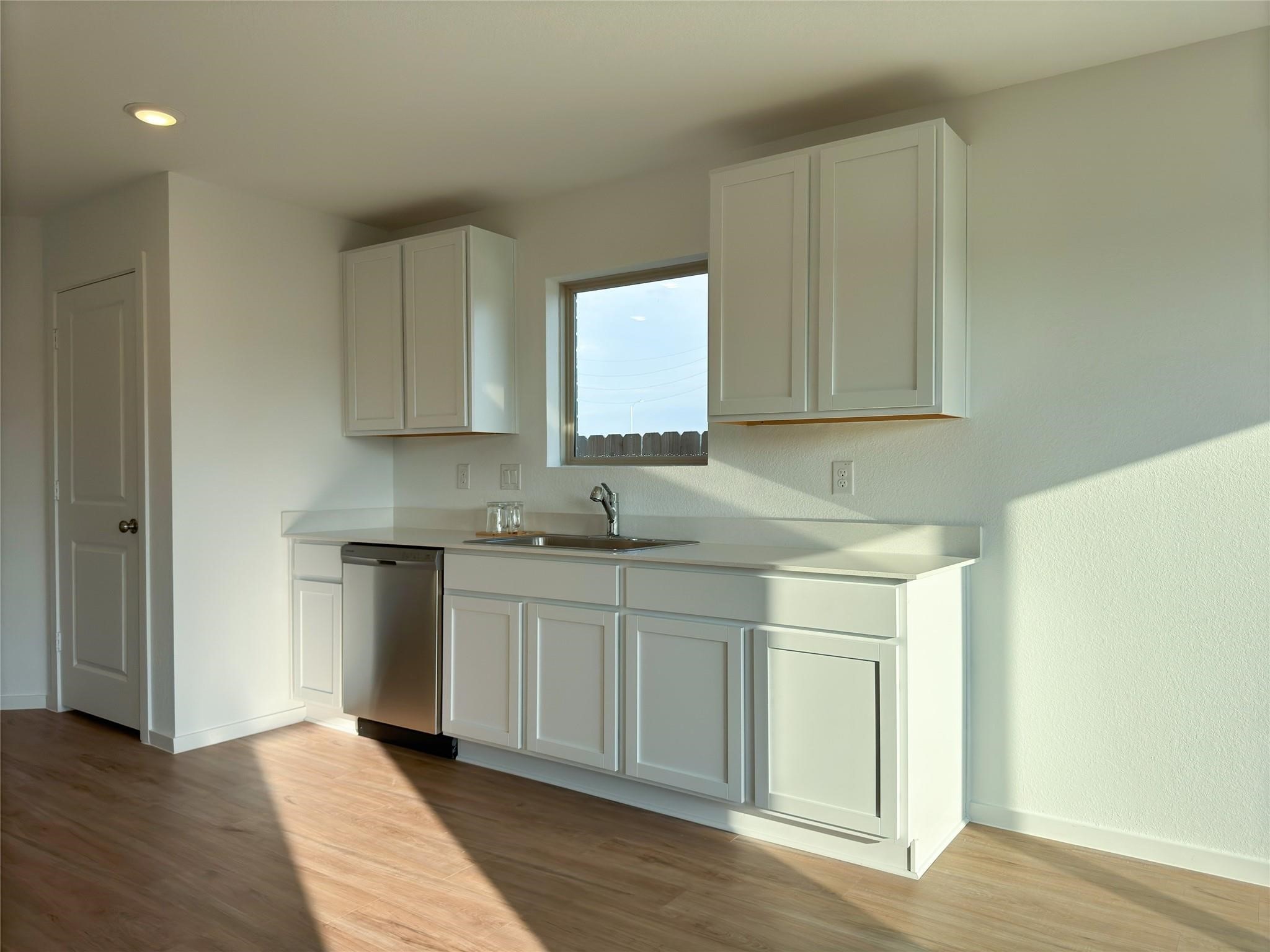 1122 Rustic Willow Drive Beasley, TX 77417 - Photo 6 of 8 a kitchen with stainless steel appliances granite countertop a sink and a stove top oven