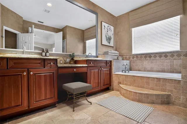 a bathroom with a granite countertop sink a toilet and shower