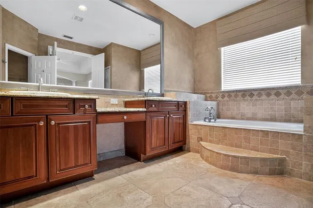 a view of a kitchen with cabinets and wooden floor